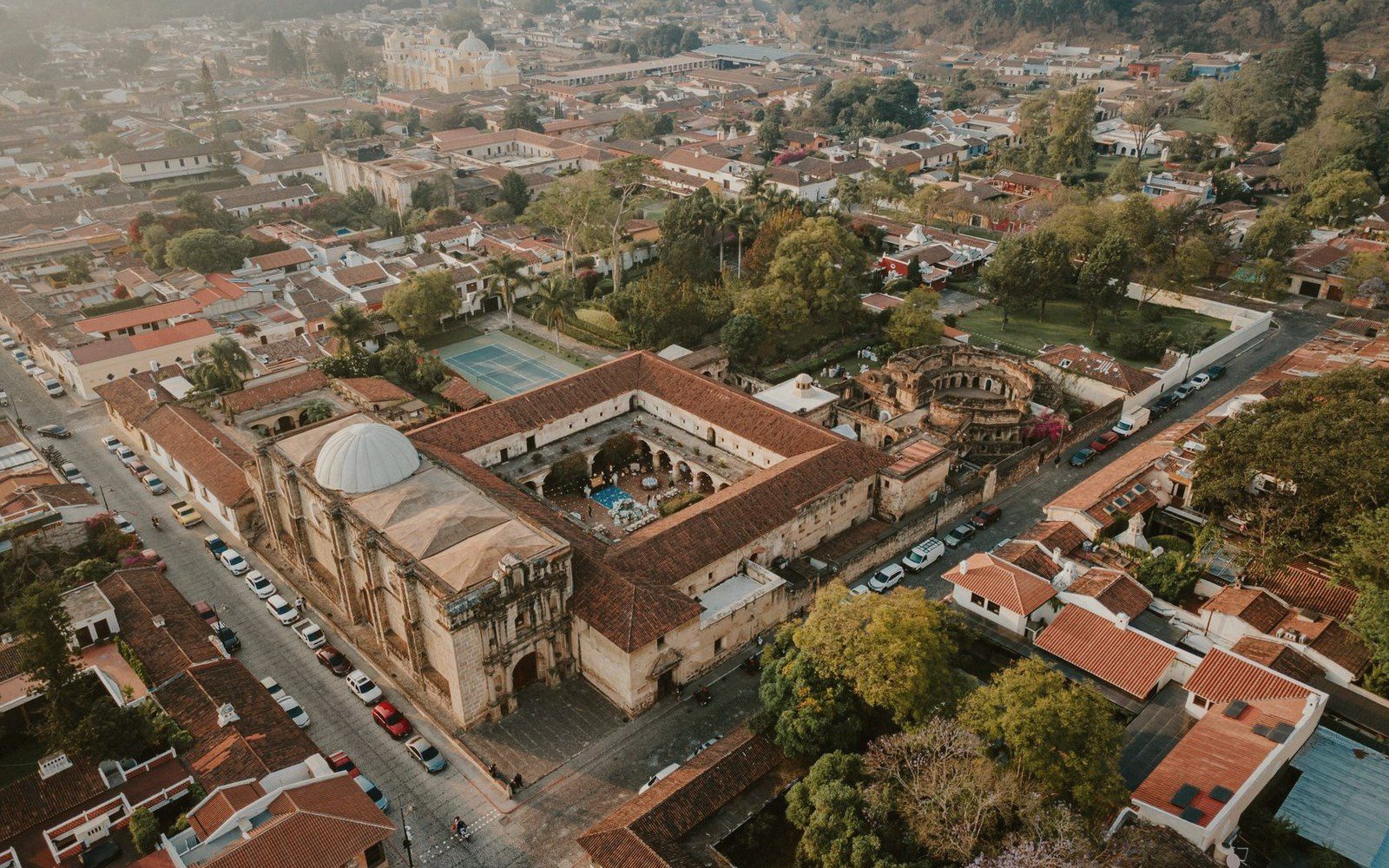 Aerial view of a colonial-grid city street pattern, rooftops and a central plaza visible